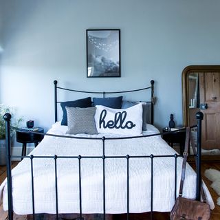 bedroom with blue wall and metal bed