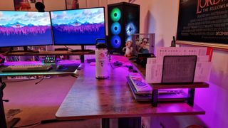 Fezibo Triple Motor L-Shaped Desk's side panel with pink lighting on