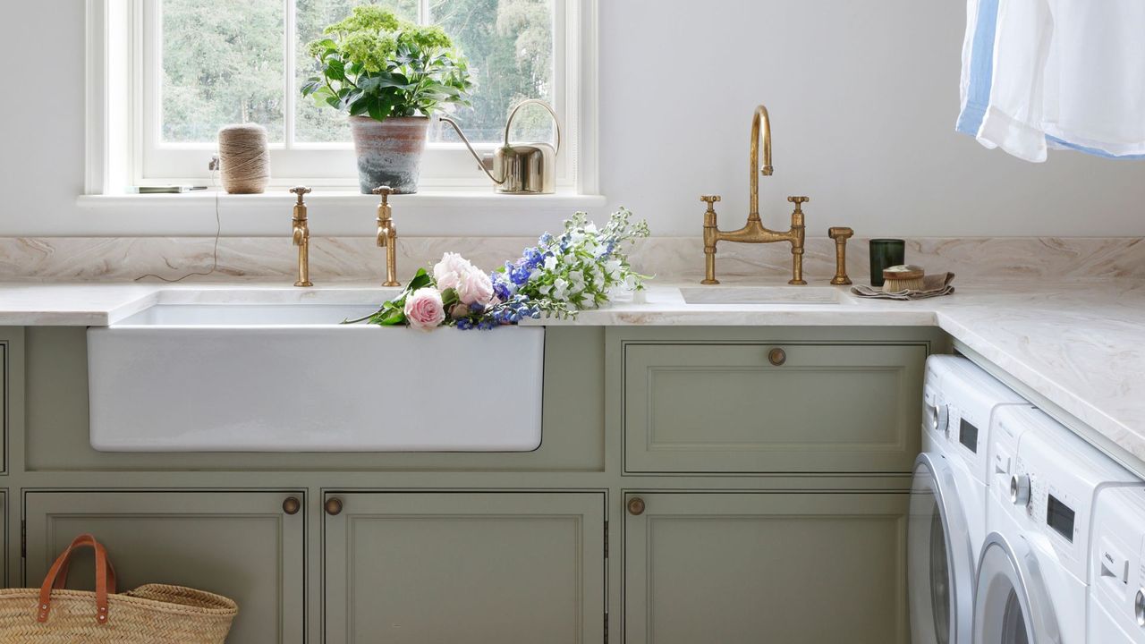 green laundry room with sinks and cabinetry