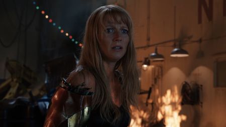 Pepper looking confused with an Iron Man arm in Iron Man 3