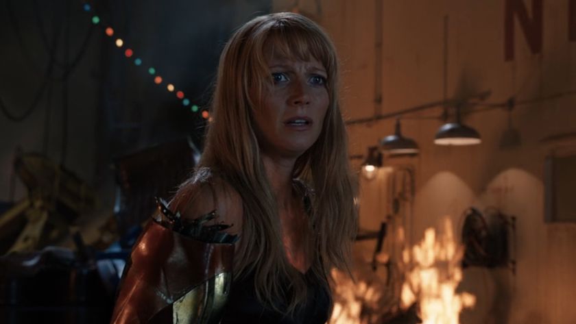 Pepper looking confused with an Iron Man arm in Iron Man 3