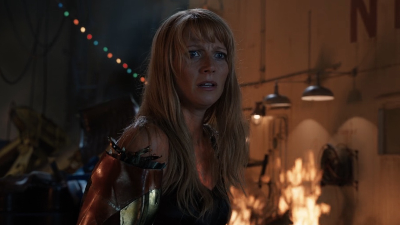 Pepper looking confused with an Iron Man arm in Iron Man 3