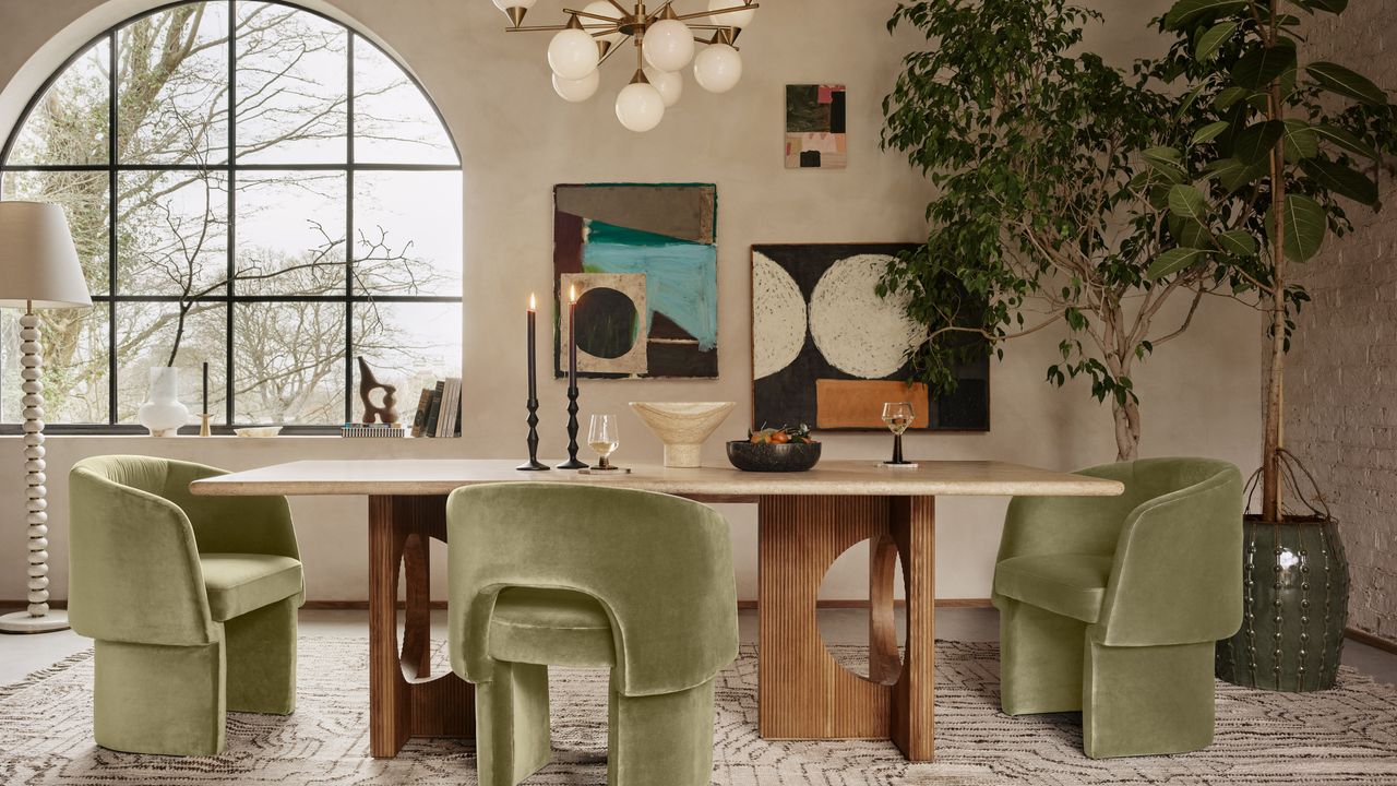 Living room with beige limewash walls, wooden dining table and olive green velvet chairs