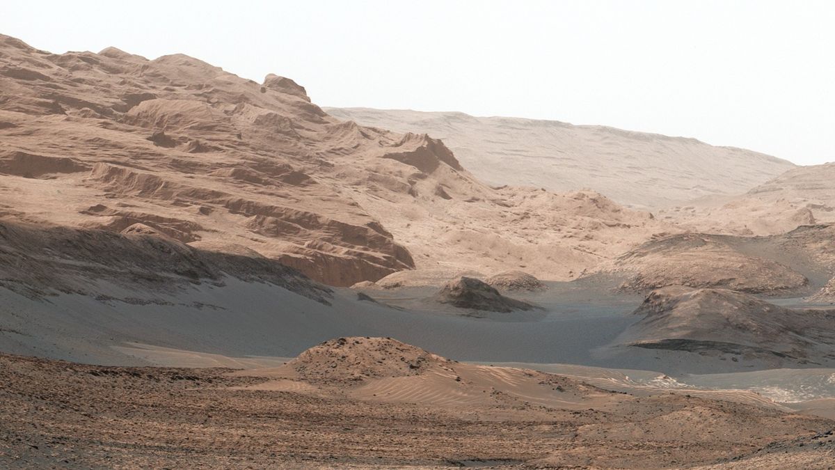 rolling hills of wind-blown red rock and dust