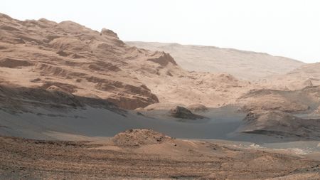 rolling hills of wind-blown red rock and dust