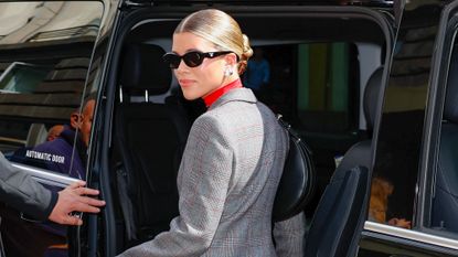 Sofia Richie leaving the Prada show in Milan wearing a suit and sunglasses