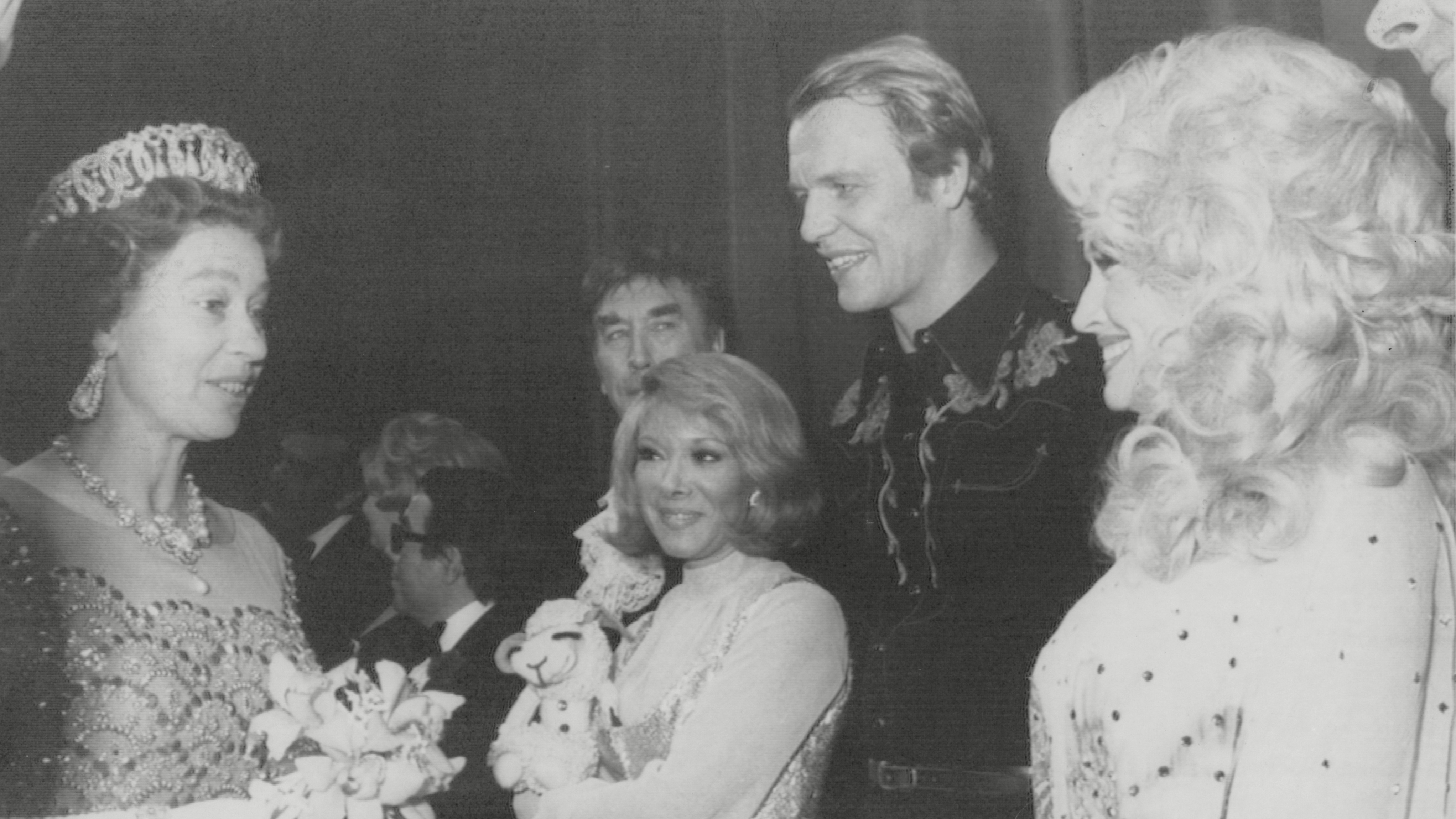 Queen Elizabeth seen chatting with Shari Lewis, David Soul and Dolly Parton after a Variety Show in Glasgow during her Silver Jubilee Tour of Scotland