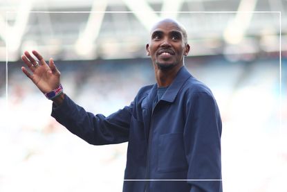 Mo Farah, who's real name is Hussein Abdi Kahin, waves to a crowd