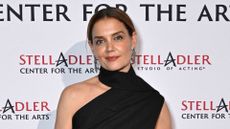 Katie Holmes wearing suit trousers, one-shoulder top and heels on October 29, 2025 in New York City