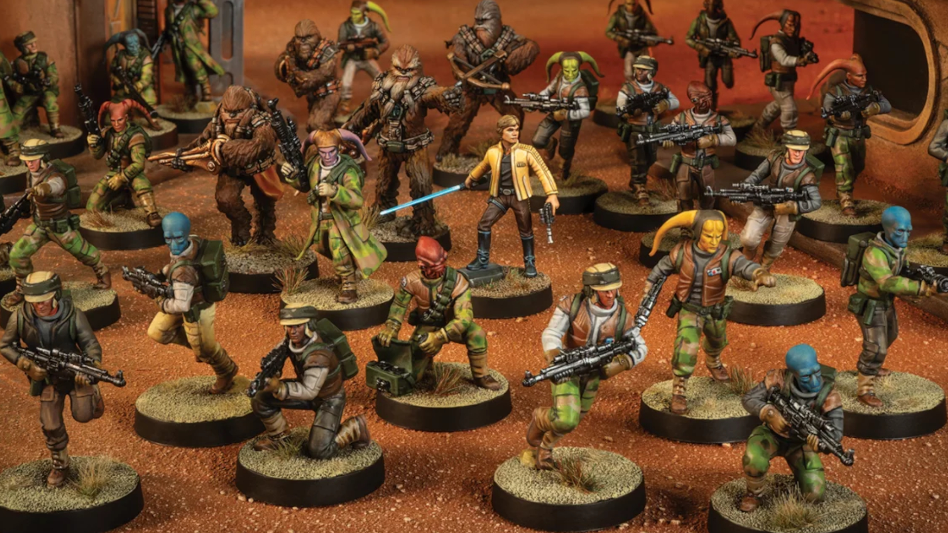 Luke Skywalker model surrounded by Rebel Alliance miniatures, all on a desert battlefield
