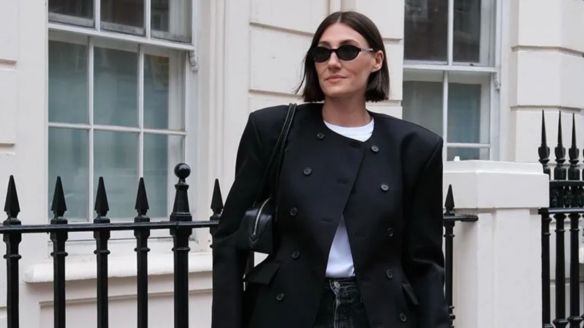 A woman wears skinny jeans with an oversized black blazer