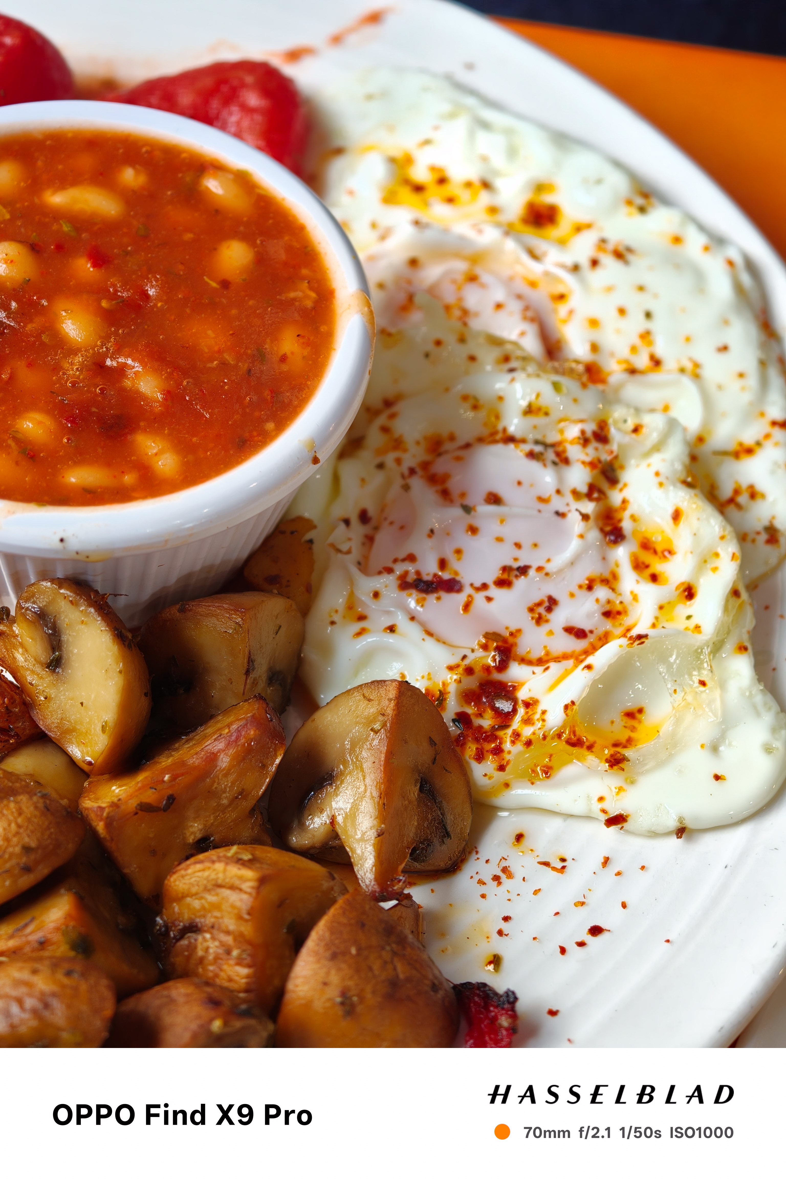 Close-up of eggs, baked beans and mushrooms on a breakfast plate