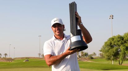 Brooks Koepka lifts up the trophy after winning the 2023 LIV Golf Jeddah title at Royal Greens Golf and Country Club