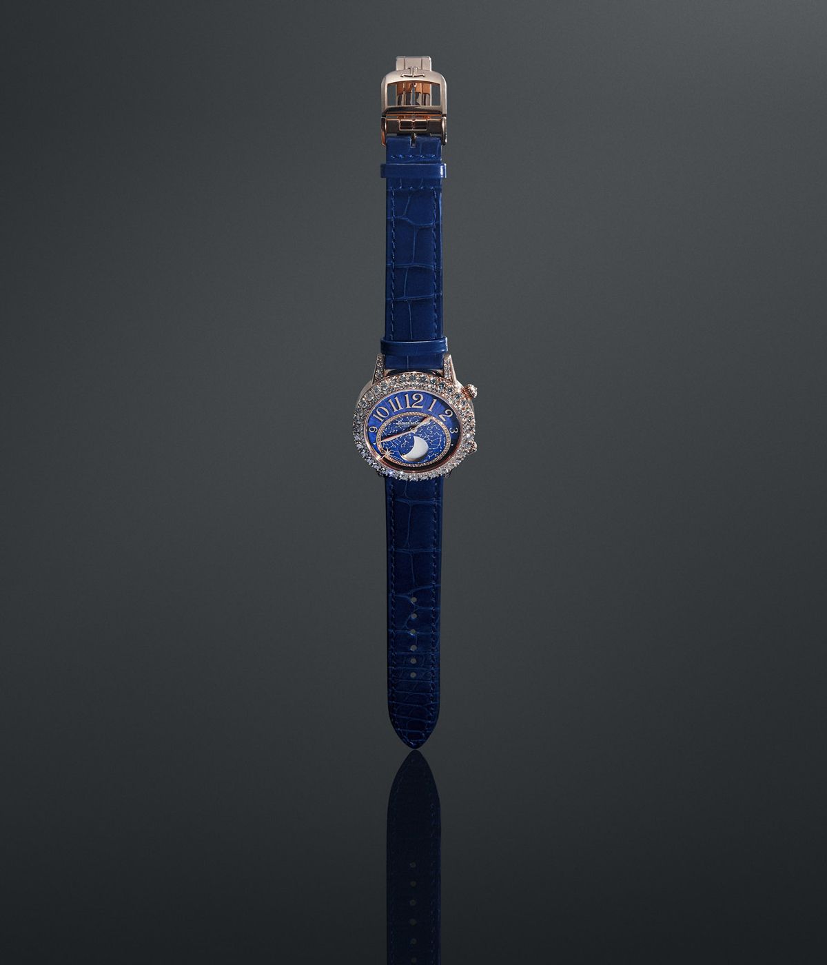 blue jaeger le-coultre watch photographed straight on against a dark background