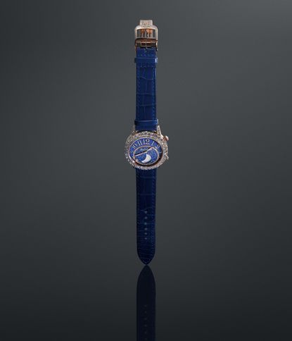 blue jaeger le-coultre watch photographed straight on against a dark background