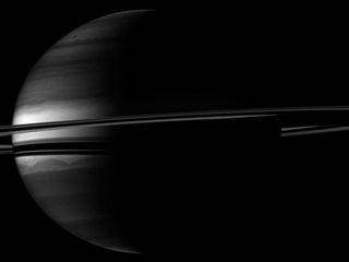 Rings enrobe crescent Saturn in this Cassini spacecraft image.