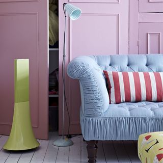 room with pink wardrobe blue sofa
