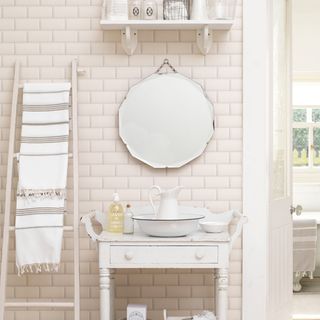 bathroom with white tiles and white vanity unit