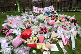 Flowers on the grass laid out for Jade Goody who died in 2009 from cervical cancer