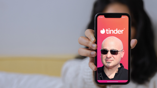 A heavily edited picture to show David Draiman's face on a phone screen with the Tinder logo
