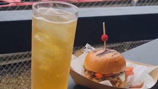 Glass of Red Bull with pulled pork sandwich by the Silverstone track