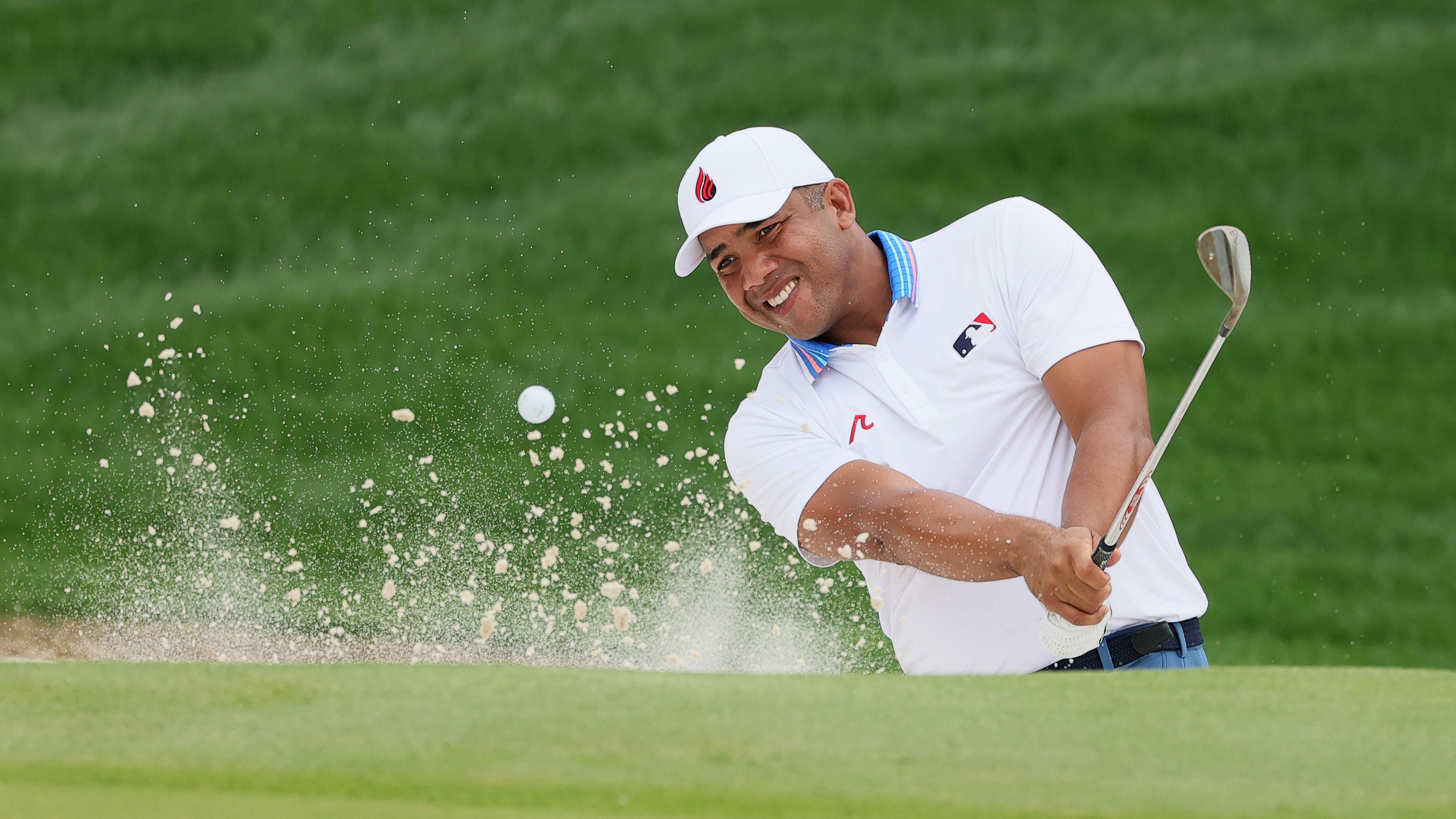 Jhonattan Vegas plays out of a greenside bunker on the 18th hole during the second round of the 2025 PGA Championship at Quail Hollow