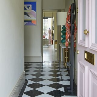 Hallway with black and white tiled patterned floors.