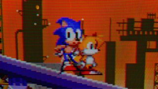 Close up of Sonic the Hedgehog 2 gameplay on Sony CRT TV with Sonic and Tails sprites standing on a slope.