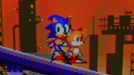Close up of Sonic the Hedgehog 2 gameplay on Sony CRT TV with Sonic and Tails sprites standing on a slope.
