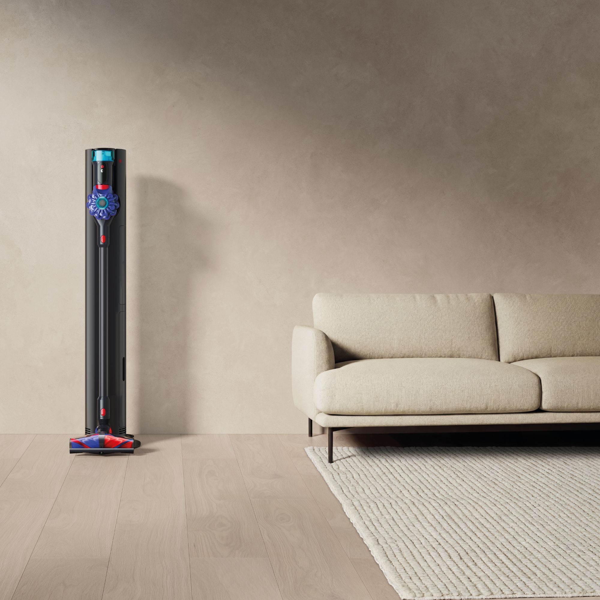 Dyson V10 Konical sitting on its dock in a minimal living room next to a white sofa