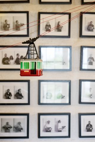 mini cable car suspended in front of photography display