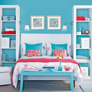 turquoise bedroom with flower vase and cushions