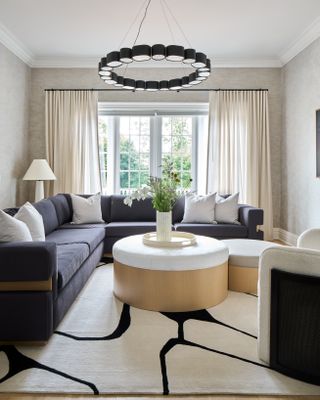 sitting room with light grey corner sofa and wood coffee table with marble worktop