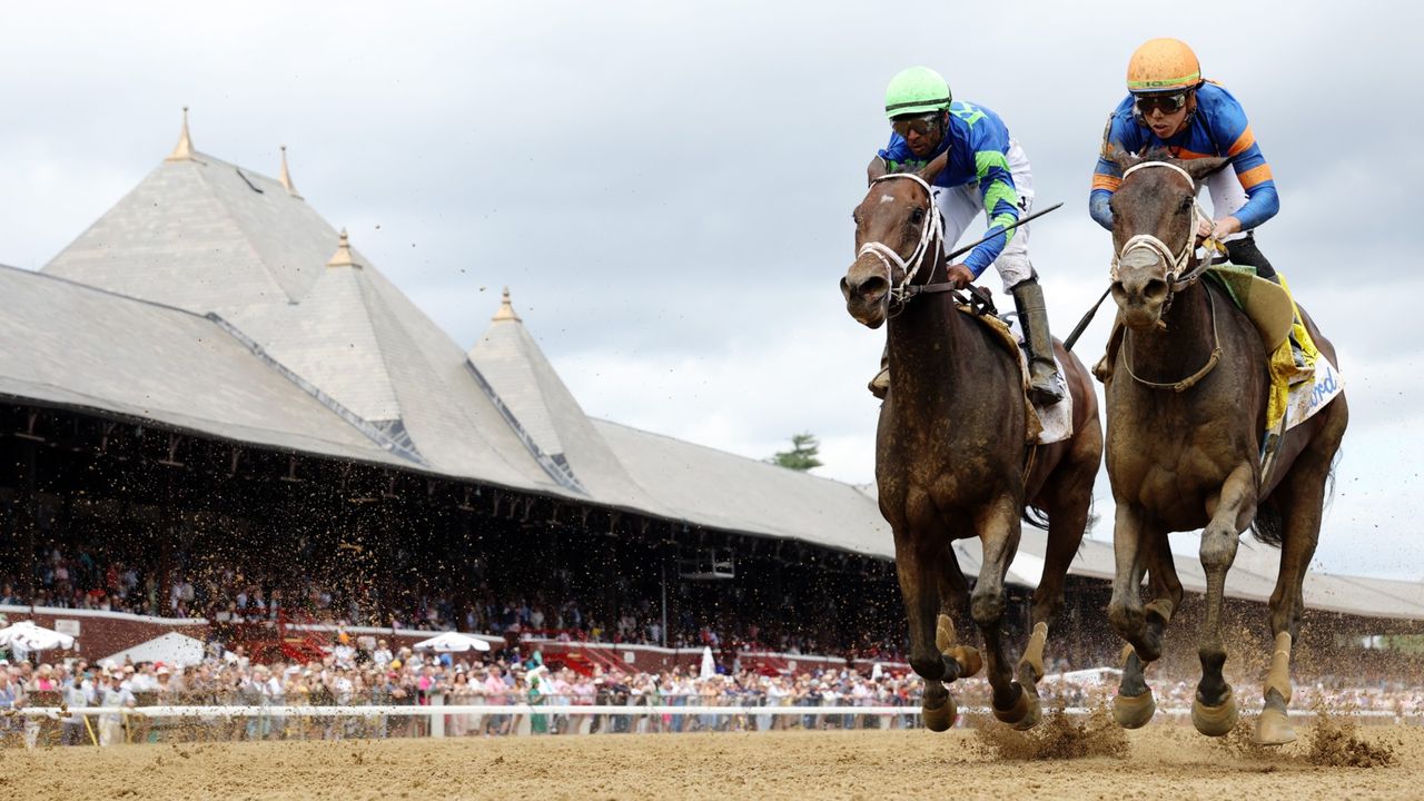 A pair of horses race in the Ogden Phipps in Saratoga Springs, New York, on June 8, 2024. 