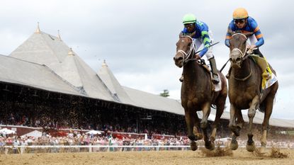 A pair of horses race in the Ogden Phipps in Saratoga Springs, New York, on June 8, 2024. 