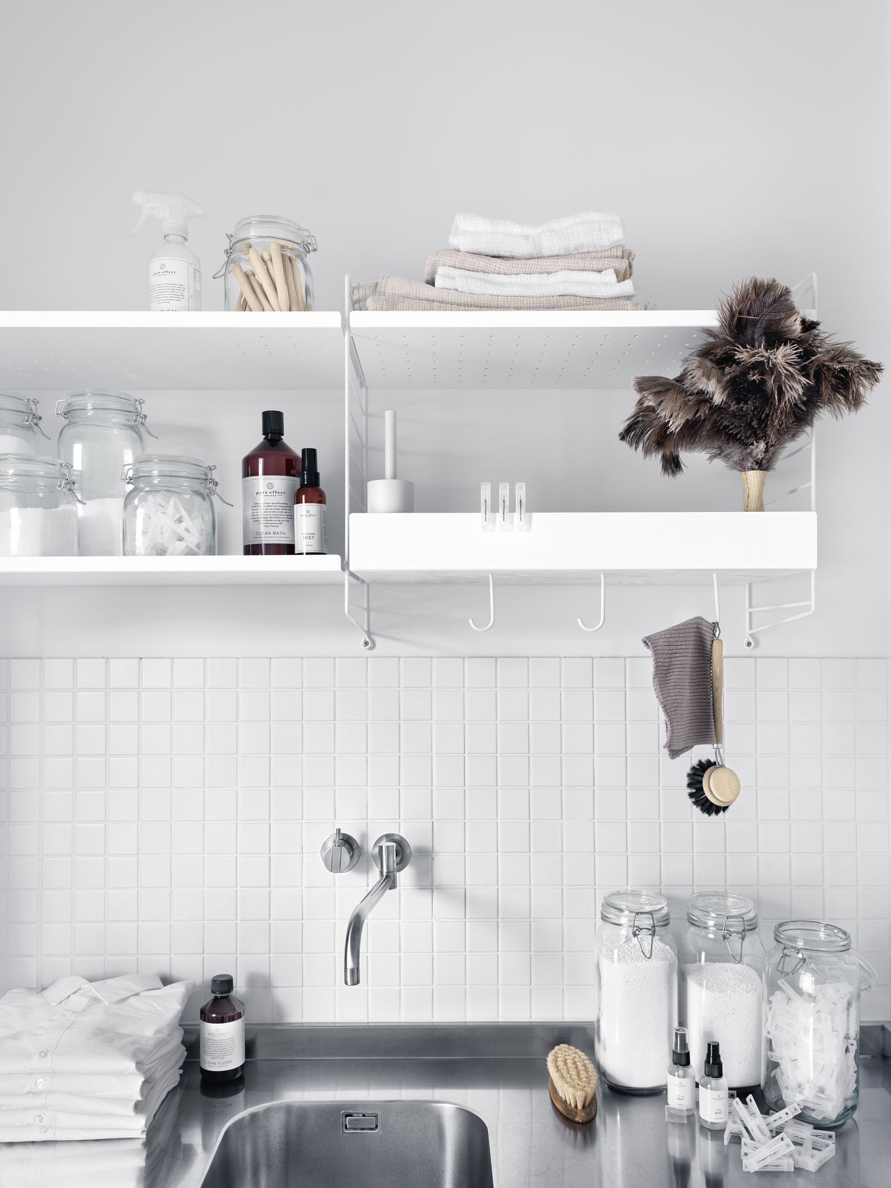utility room shelving with white modular shelves and white tiles