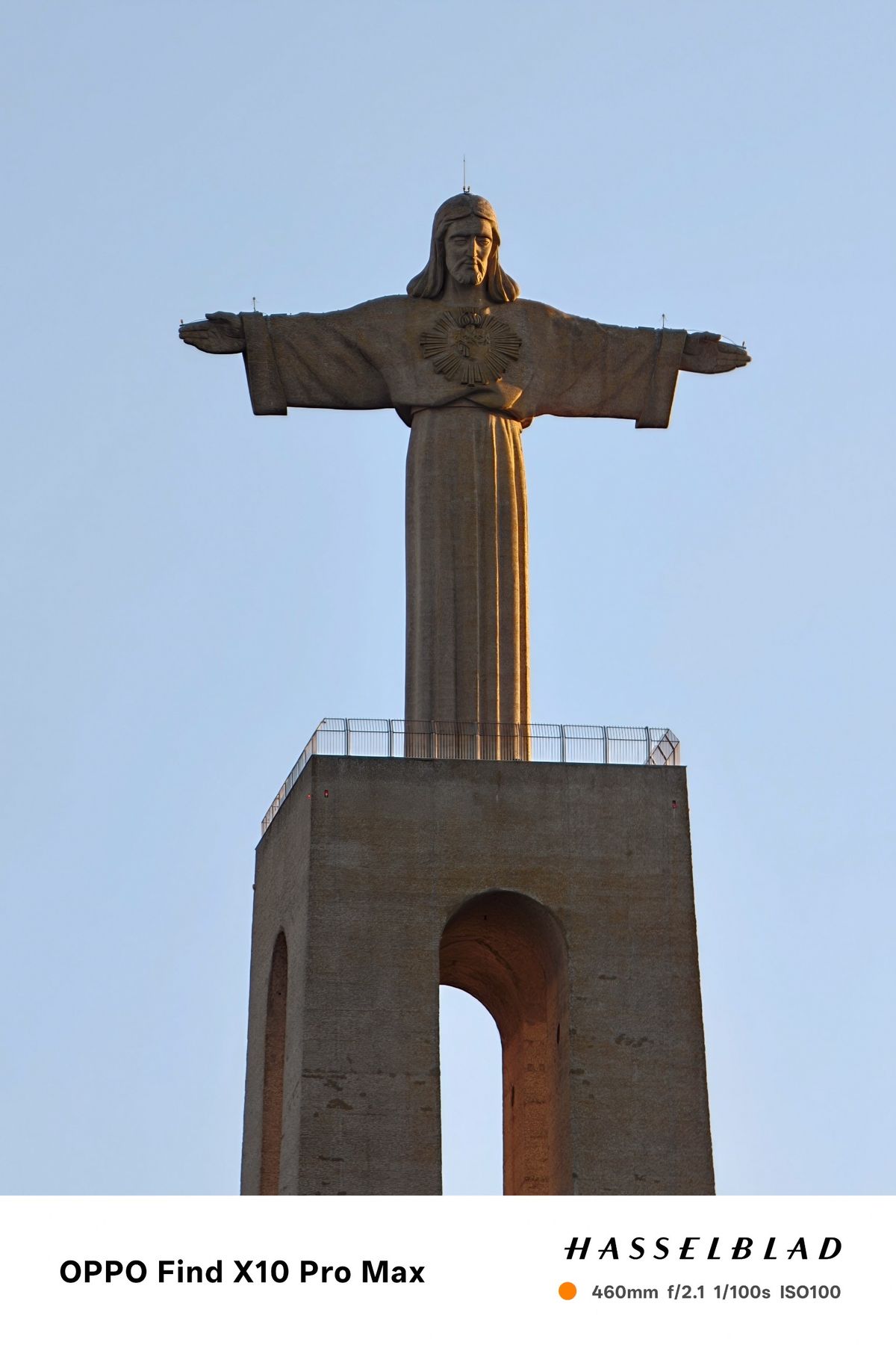 Close-up view of the Cristo Rei monument against a clear blue sky.