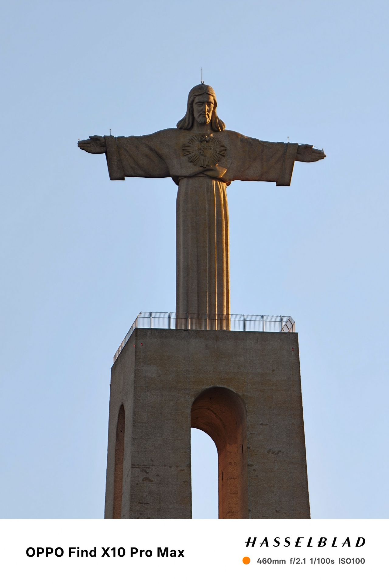 Close-up view of the Cristo Rei monument against a clear blue sky.