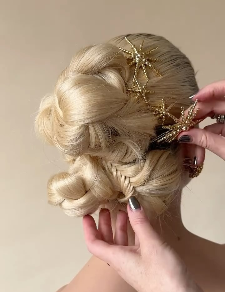 A model wears a twisted updo with a mini braid detail Lelet NY hair barrettes