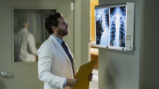 Edgar Ramirez as Paolo looking at an X-ray in Dr. Death season 2