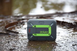 Zoleo Satellite Communicator GPS tracking device on muddy ground outdoors