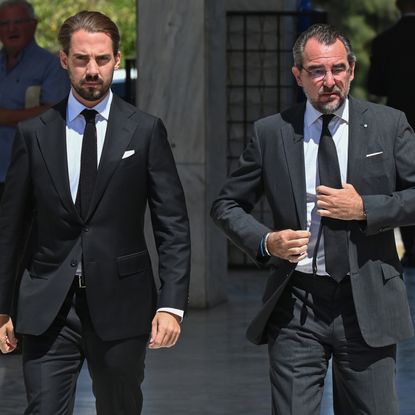 Prince Philippos of Greece and Prince Nikolaos of Greece wearing a black suit attending the funeral of Prince Michael of Greece at the First Cemetery of Athens