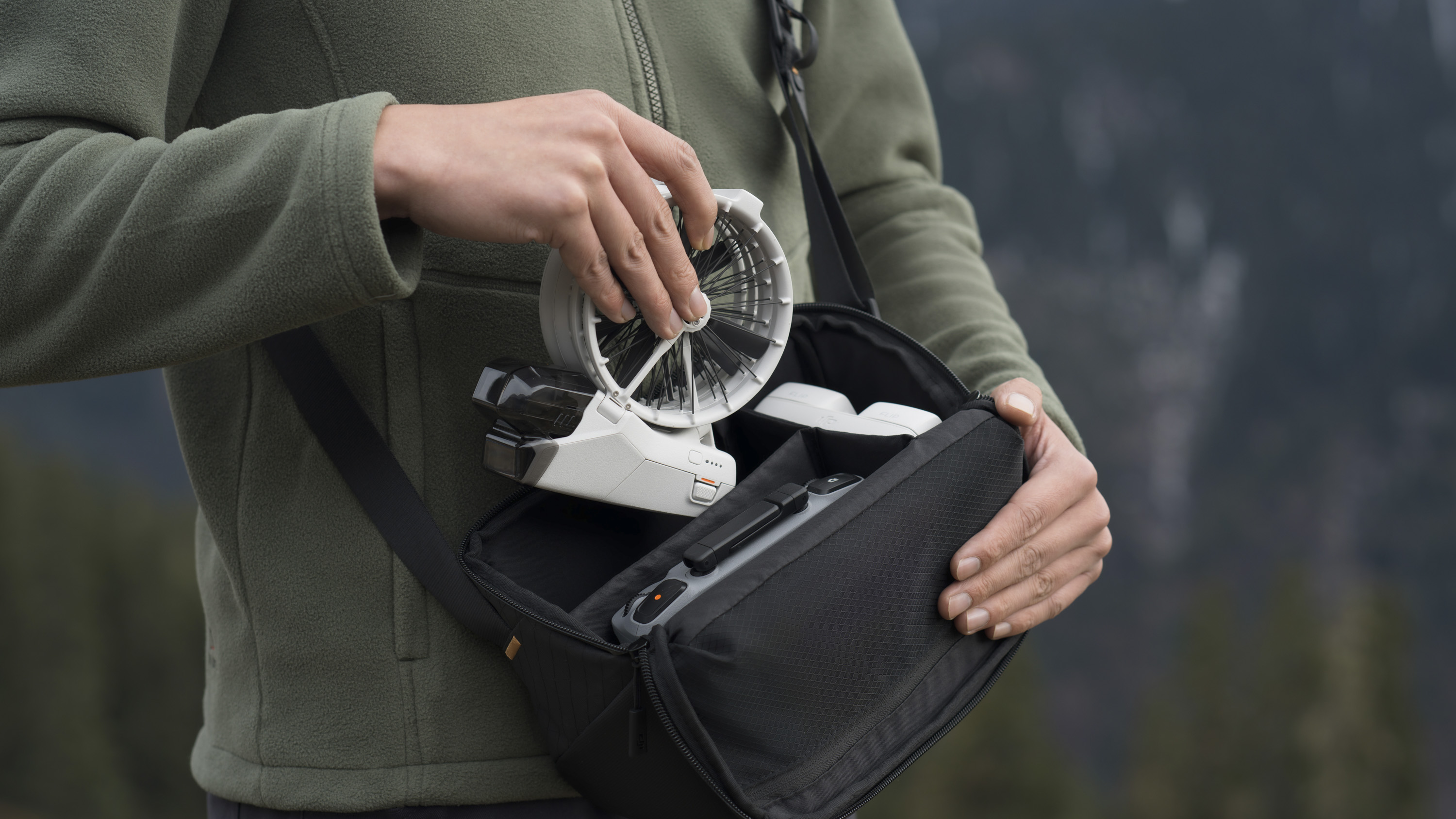 Person removing the DJI Flip drone from a bag