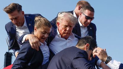 Former President Donald Trump is rushed offstage by U.S. Secret Service agents after being grazed by a bullet during a rally on July 13, 2024 in Butler, Pennsylvania