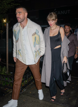 Travis Kelce and Taylor Swift are seen leaving the SNL after party on October 15, 2023 in New York, New York. Taylor carries an Aupen Nirvana bag.