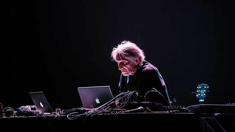 Manuel Gottsching hunches over a laptop at the Barbican,
