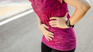 A runner with a stitch holding her side