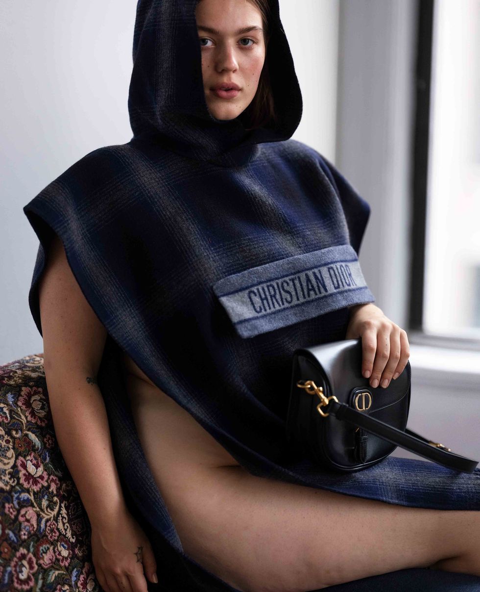 Model in Christian Dior top with handbag