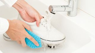soapy sponge cleaning white shoes