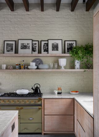 Rustic wooden kitchen with white exposed brick wall and open shelving